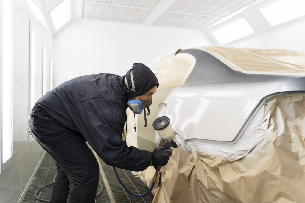 service worker painting car auto service